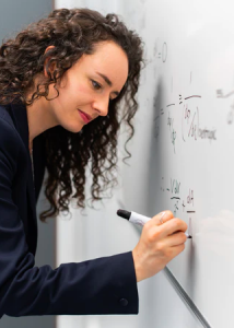 Teacher teaching math on a white board